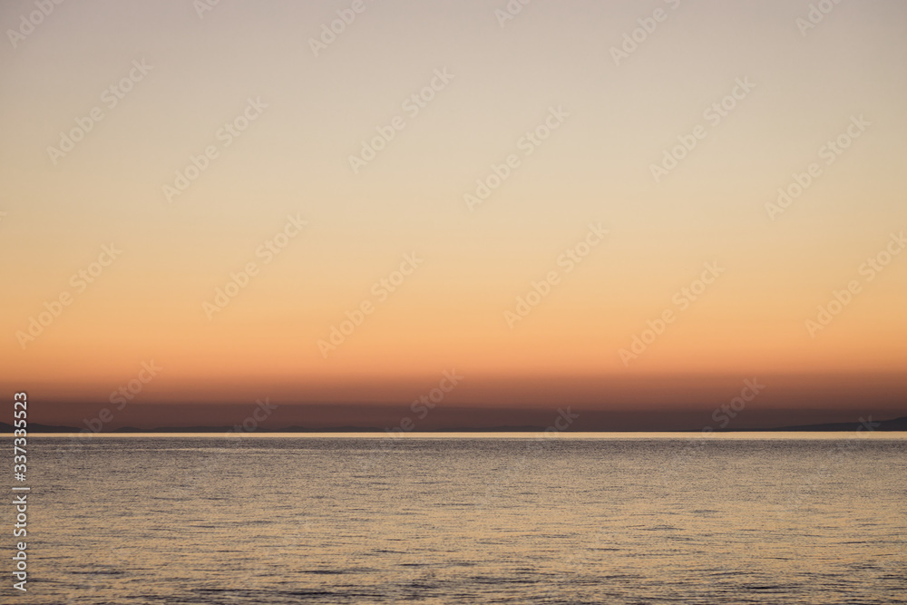 Beautiful orange sunset on the sea horizon