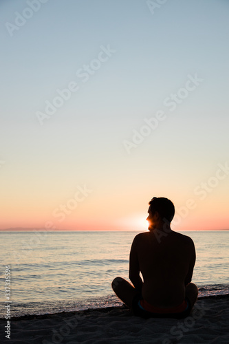 Young man enjoying sunset on the beach