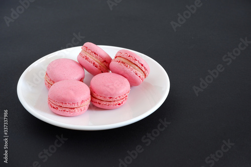 Macaroons on a black background. Sweets photo