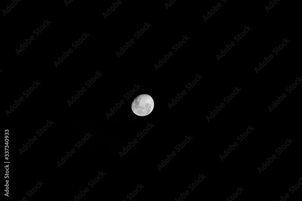 Bright moon highlighting the deep craters taken over Sydney NSW Australia on a dark cloudy night Bright moon highlighting the deep craters taken over Sydney NSW Australia on a dark cloudy night