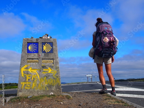 Pilgrim and Camino waymark at the Finisterre and Muxia, Camino de Santiago, Way of St. James, Journey from Santa Marina to Dumbria, Fisterra-Muxia way, Spain