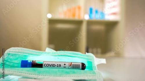 Fototapeta Naklejka Na Ścianę i Meble -  The Covid-19 positive of coronavirus and the facemask 