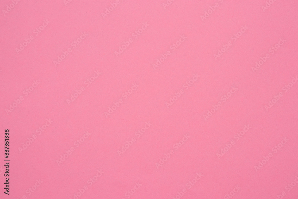 A sheet of paper is a soft pink, coral color. Close-up. The background is a muted, dusty shade. Daylight. Fine paper texture. Space for text A sheet of paper is a soft pink, coral color. Close-up. The background is a muted, dusty shade. Daylight. Fine paper texture. Space for text