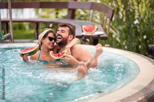 Hugging couple in swimming pool