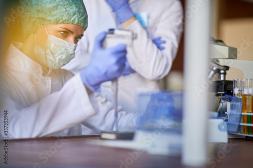 Lab worker with protecting gear working