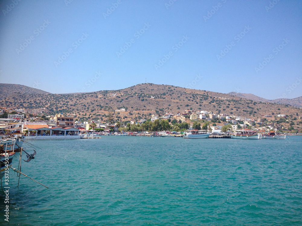 Elounda, Crete, Greece - September 2: View of the sea bay with boats. Mountains are visible in the distance.