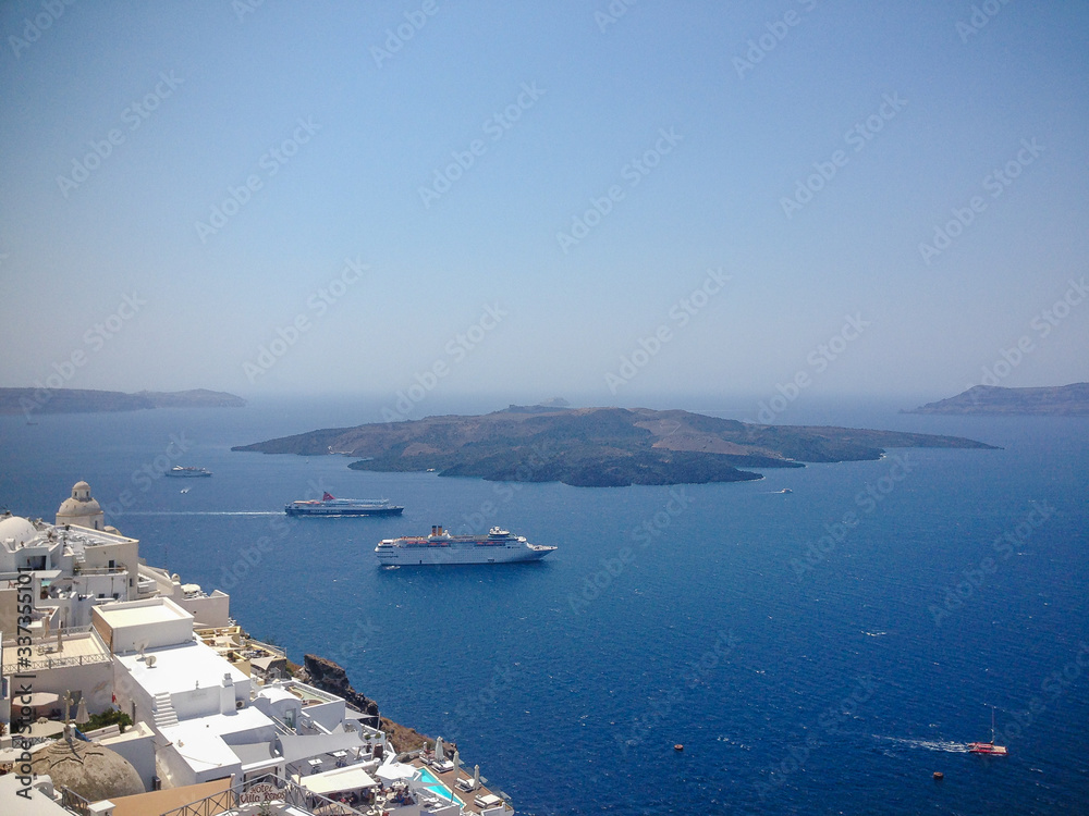 SANTORINI, GREECE - SEPTEMBER 10: ships and ferries sail in the Mediterranean Sea of Oia near the island of Santorini, Greece.