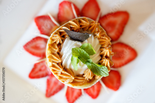 desert with strawberries, caramell, cream and mint photo