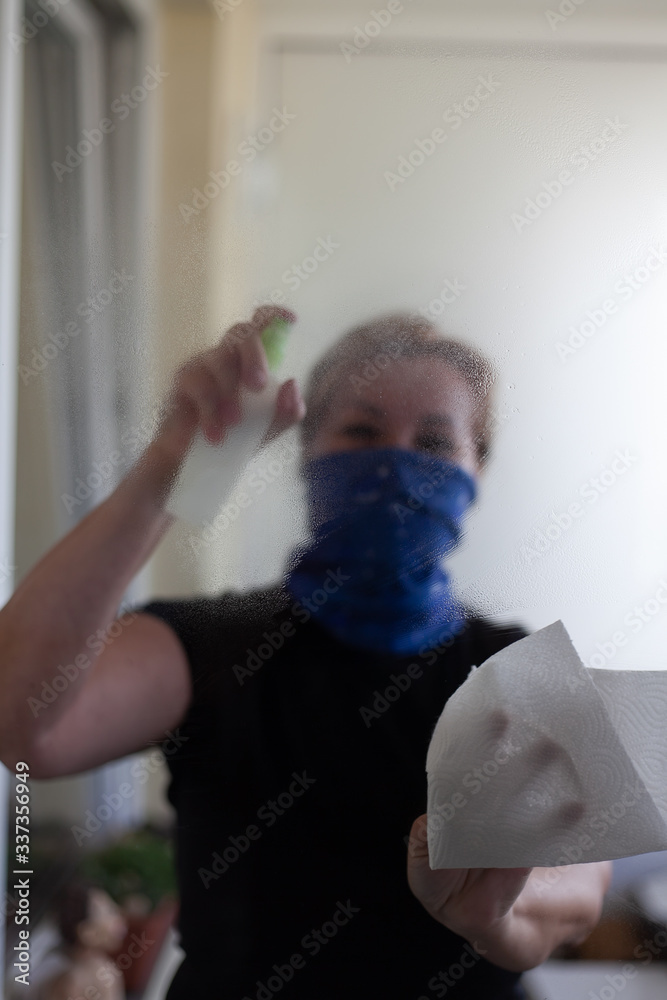 Covid 19. A woman in a mask cleans and disinfects the apartment.
A period of worldwide influenza pandemic. Looking for better tomorrows.