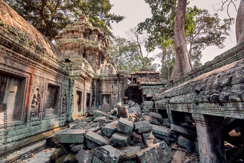 Huge bricks of broken walls of the famous temple Ta Prohm, 12th century structure, Cambodia. Historical complex of Angkor in tropical forest. UNESCO world heritage site