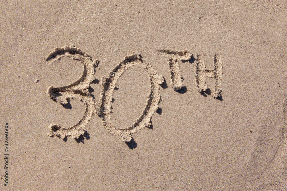 thirtieth written in beach sand