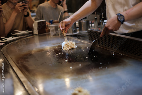 Fotografija He stir fry food in a flat pan