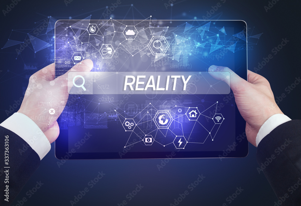 Obraz premium Close-up of a tablet searching REALITY inscription, hi-tech computing concept