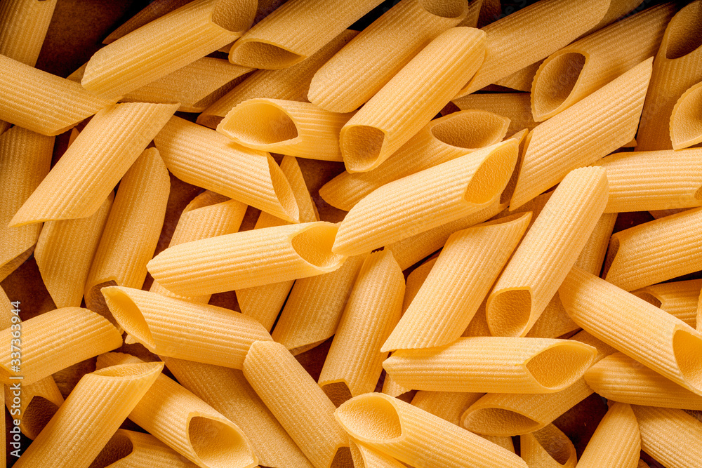 italian penne pasta, closeup on detail, culinary background
italian penne pasta, closeup on detail, culinary background
