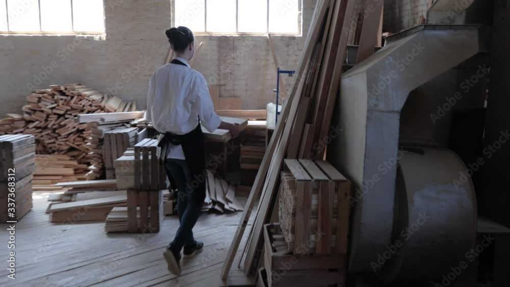 Confident woman working as carpenter in her own woodshop Confident woman working as carpenter in her own woodshop