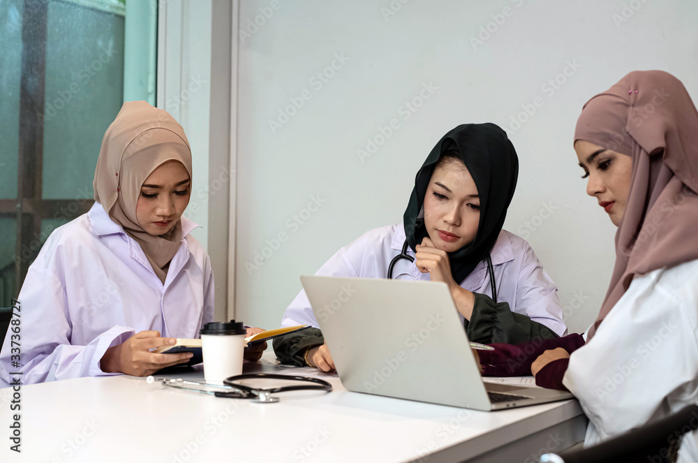 Three female doctors working together,consult about patient case,at hospital Three female doctors working together,consult about patient case,at hospital
