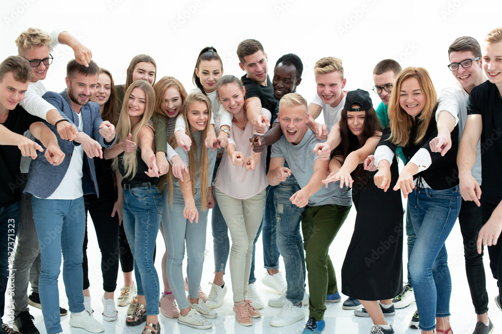 group of diverse young people pointing at one point.