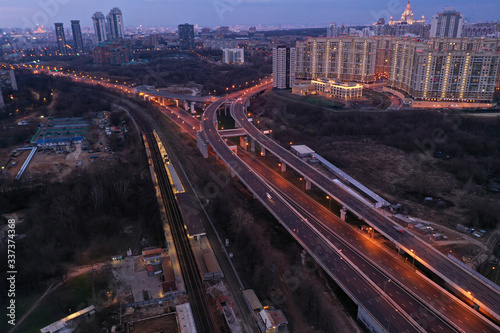 the lights of the big city and the motorway at night shot from the drone