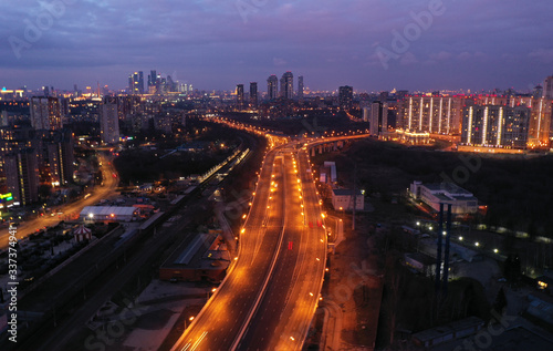 the lights of the big city and the motorway at night shot from the drone © константин константи