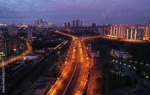 the lights of the big city and the motorway at night shot from the drone