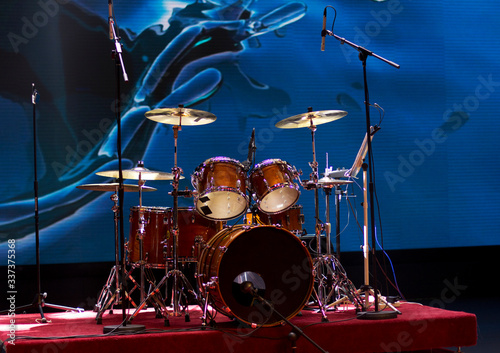 Drum set on a blue background. Drums on stage.