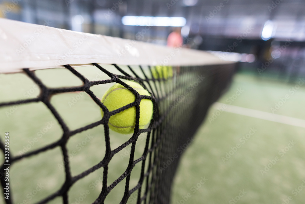 Ball shot versus the net, paddle tennis image. 