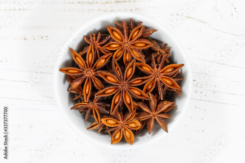 Fototapeta Naklejka Na Ścianę i Meble -  Star anise star-anise Christmas spice herb from above bowl on a wooden board