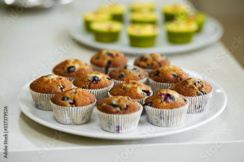 Plate with freshly baked sweet muffins. Sweet pastries, recipes, cooking