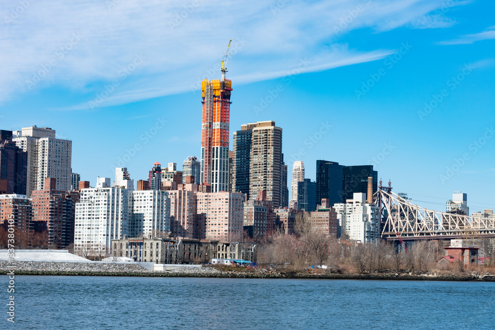 Midtown Manhattan Skyline along the East River in New York City with the Queensboro Bridge and Construction