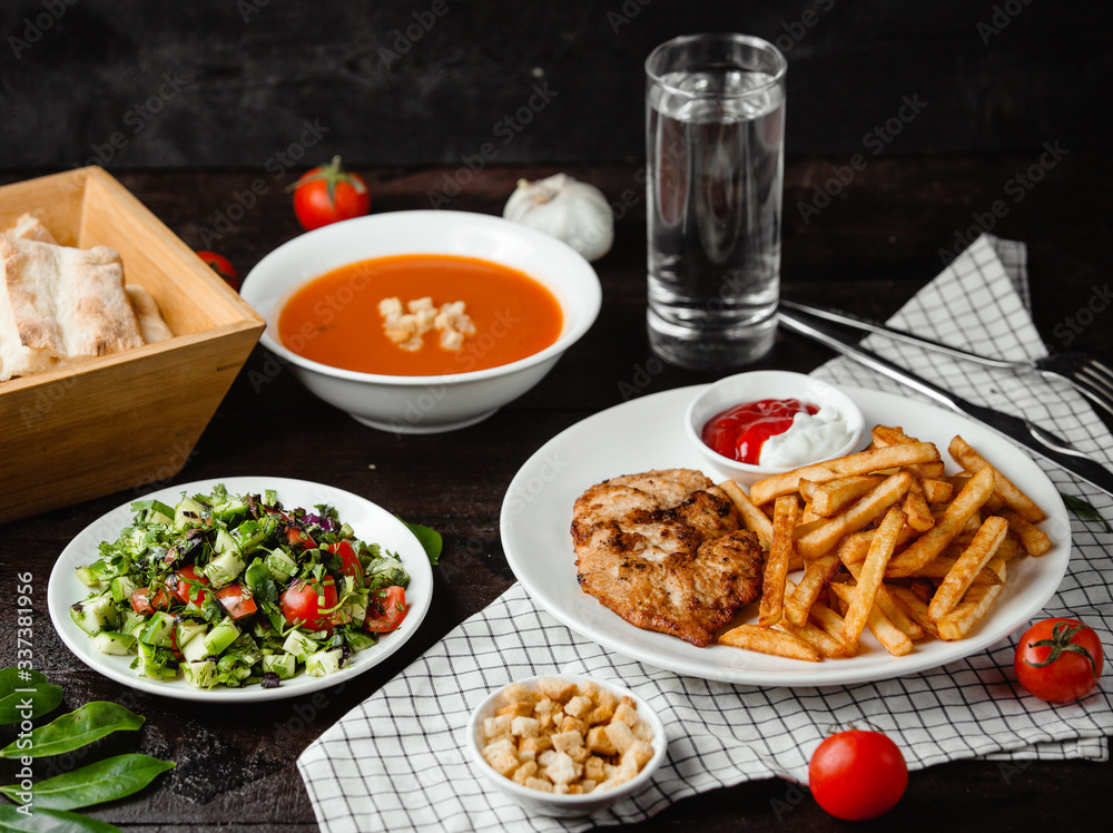 tomato soup, vegetable salad and chicken with french fries