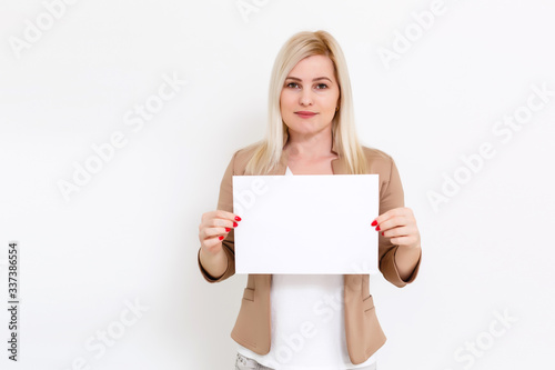 Your text here. Pretty young excited woman holding empty blank board. Studio portrait on white background. Mock up for design