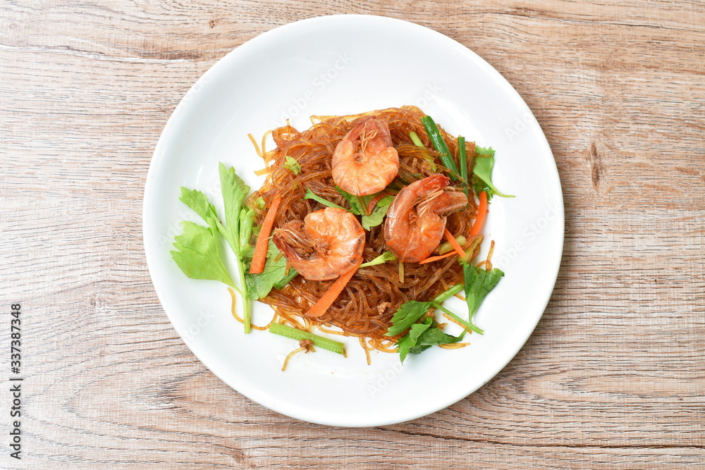 baked glass noodles with slice carrot and celery topping shrimp on plate baked glass noodles with slice carrot and celery topping shrimp on plate
