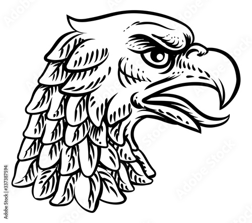 An eagle, falcon hawk or phoenix head face mascot in engraved style.