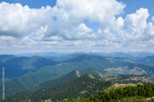 Fototapeta Naklejka Na Ścianę i Meble -  Ridge with grassy slopes and fir trees. Mountains and valleys of Carpathians in a far distance. beautiful summer scenery of Ukraine