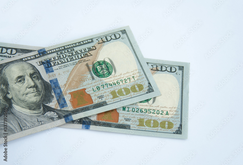Hundred dollar banknotes lying on each other, isolated on white background Hundred dollar banknotes lying on each other, isolated on white background