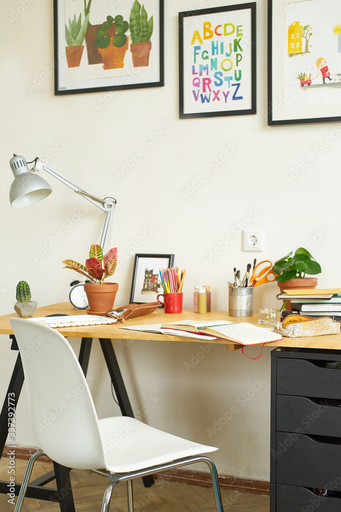 Artist's workplace for working from home with watercolor paints, brushes and sketchbooks. Place for design, illustration and creativity.