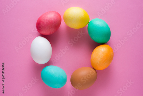 Easter eggs on a pink background from above © Ivan