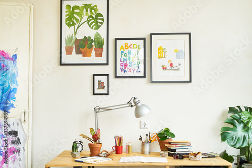 Artist's workplace for working from home with watercolor paints, brushes and sketchbooks. Place for design, illustration and creativity. © Anastasiia Nurullina