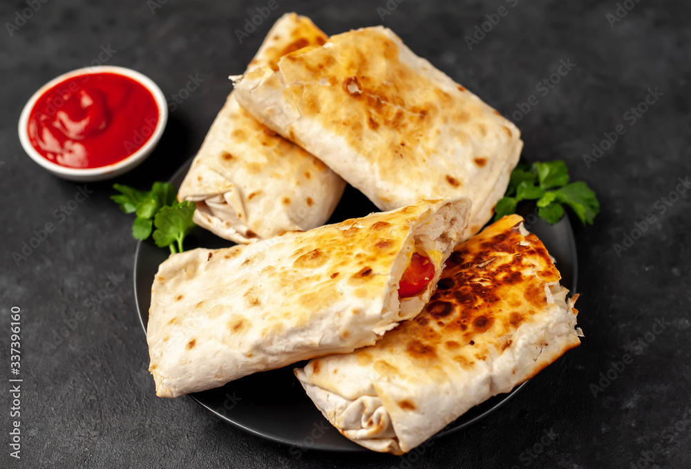 Burrito wraps with chicken and vegetables
in a black plate , against a background of concrete ,
Mexican shawarma Burrito wraps with chicken and vegetables
in a black plate , against a background of concrete ,
Mexican shawarma