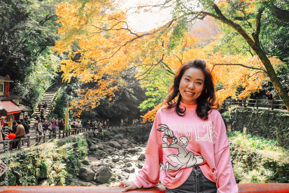 Asian woman tourist come to see autumn leaves in garden in spring season at Kyoto, Japan. Autumn leaves is attraction for tourist in Japan. Asian woman tourist come to see autumn leaves in garden in spring season at Kyoto, Japan. Autumn leaves is attraction for tourist in Japan.