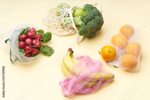 Fototapeta Naklejka Na Ścianę i Meble -  Zero waste food shopping with reusable bags. Flat lay with fruits and vegetables in textile packaging