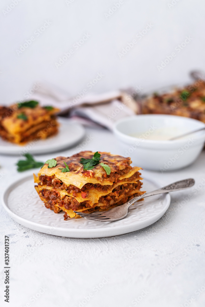 Delicious homemade italian Lasagna with bachamel sauce on gray background. Hot tasty Lasagna with cheese Delicious homemade italian Lasagna with bachamel sauce on gray background. Hot tasty Lasagna with cheese