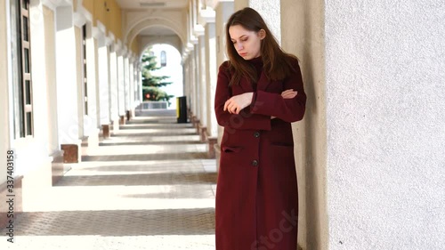Close-up portrait of attractive girl looking away, on the city street background