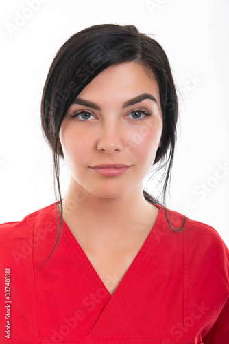 Portrait of young attractive female nurse posing at camera