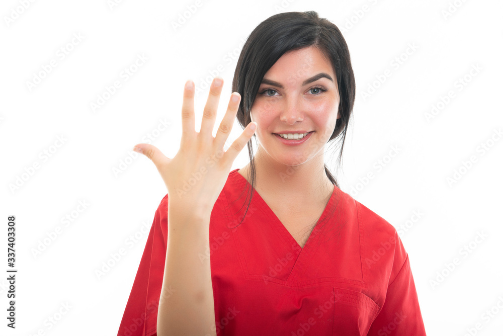 Portrait of young attractive female nurse showing number five Portrait of young attractive female nurse showing number five