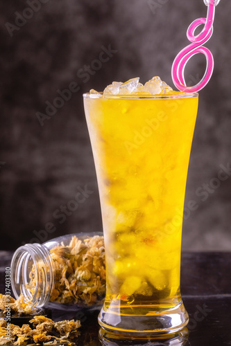Water of chrysanthemum flowers and dried chrysanthemum flowers in glass bottle.