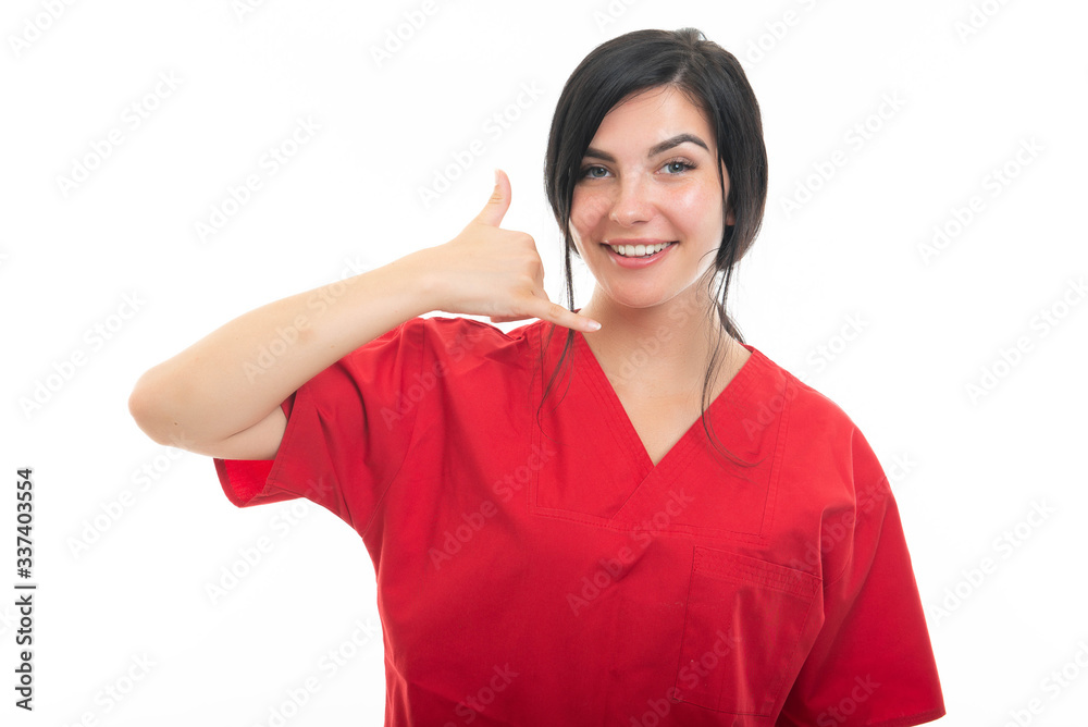 Portrait of attractive female nurse making calling gesture Portrait of attractive female nurse making calling gesture