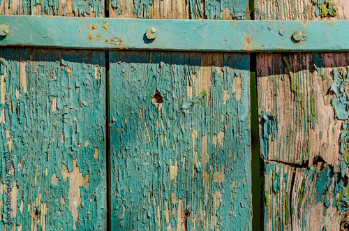 Old boards covered with peeling green paint