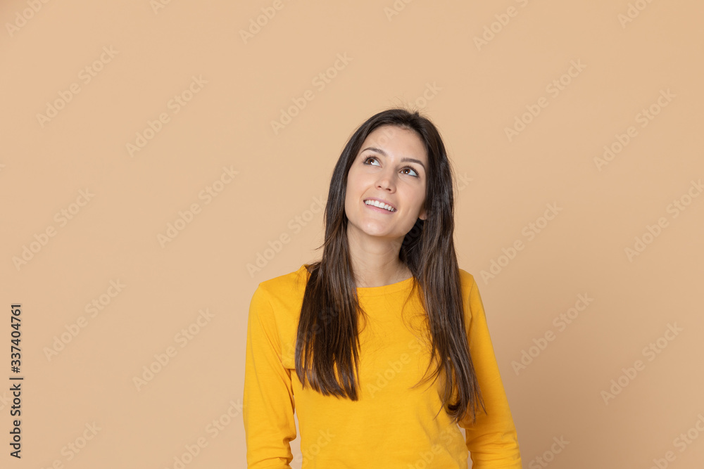 Brunette young woman wearing a yellow T-shirt Brunette young woman wearing a yellow T-shirt