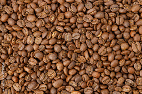Aromatic roasted coffee beans background. Texture top view.